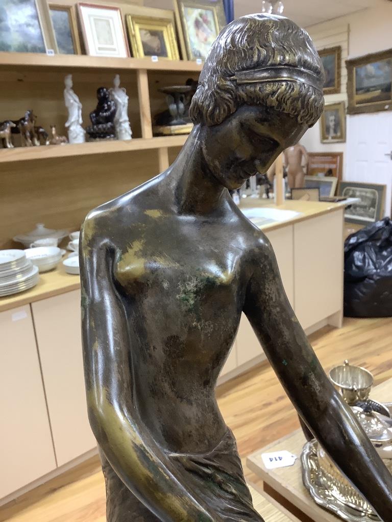 An Art Deco style bronze lady and a marble sphere, on marble base, length 76cm